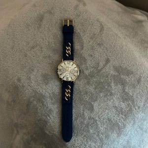 Blue watch with gold chain needs a battery